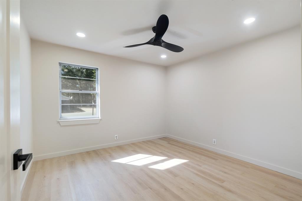 1195 33rd Street Southeast Paris, TX 75460 - Photo 2 of 34 a view of empty room with ceiling fan and window