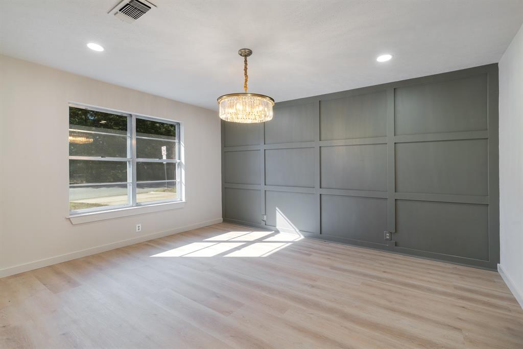 1195 33rd Street Southeast Paris, TX 75460 - Photo 3 of 34 a view of an empty room with wooden floor and a window