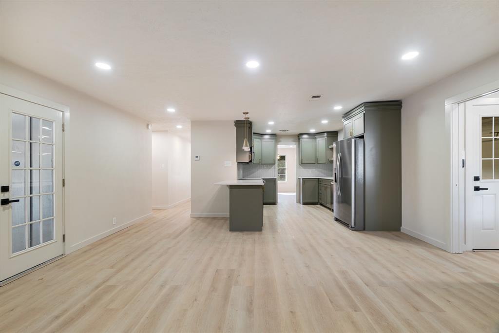 1195 33rd Street Southeast Paris, TX 75460 - Photo 7 of 34 a kitchen with stainless steel appliances kitchen island a refrigerator sink and cabinets
