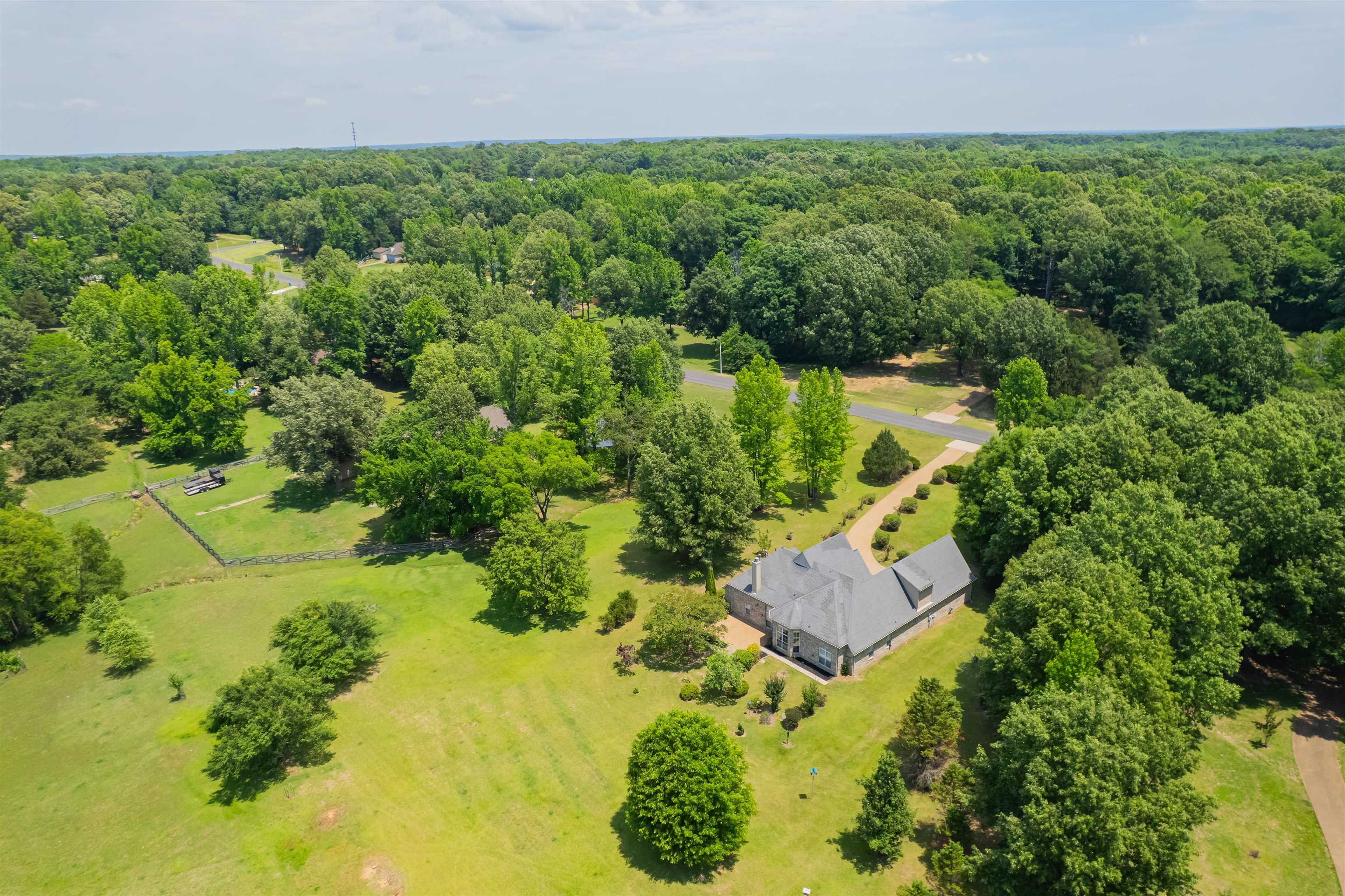 5035 Brian Ridge Road Arlington, TN 38002 - Photo 30 of 40 Expansive property featuring a large residence with a gray roof and a substantial green lawn