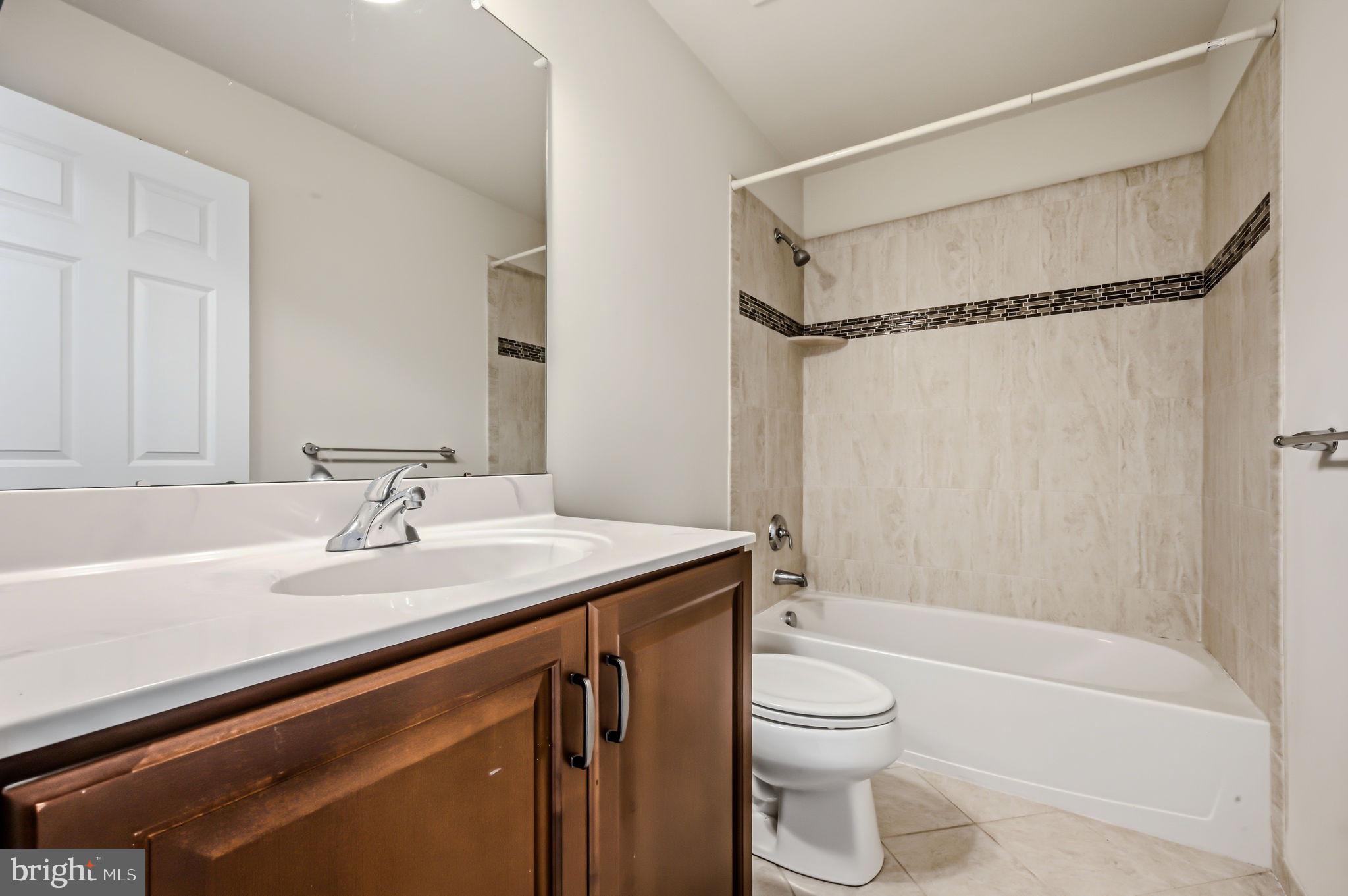 208 Jackdaw Alley, Unit 208 Springfield, PA 19064 - Photo 38 of 49 a bathroom with a granite countertop sink toilet and shower