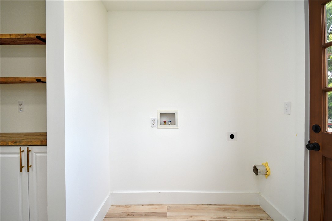 407 I Street Anderson, SC 29625 - Photo 22 of 43 A dedicated laundry room with hookups and built-in shelving offers convenience and organization.