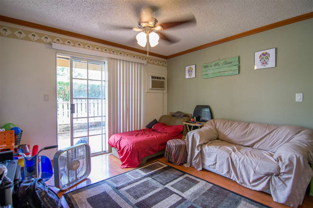 140 Uwapo Road, Unit 49104 Kihei, HI 96753 - Photo 2 of 13 a living room with furniture and a chandelier
