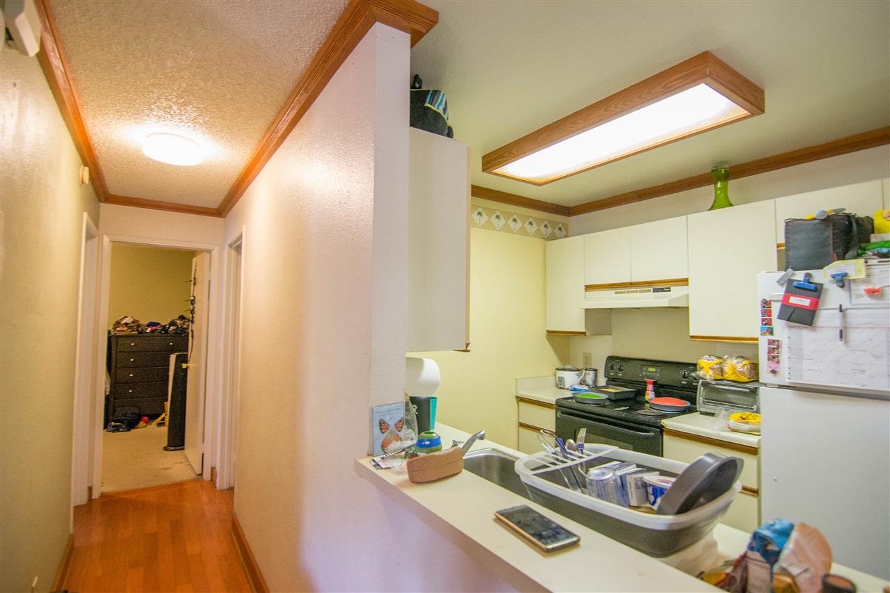 140 Uwapo Road, Unit 49104 Kihei, HI 96753 - Photo 4 of 13 a kitchen with a refrigerator and a stove top oven