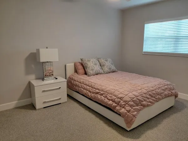a bedroom with a bed and a lamp