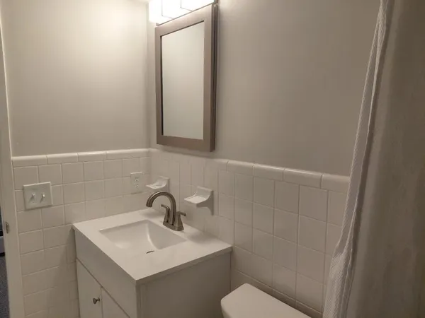 a white toilet sitting next to a bathroom sink