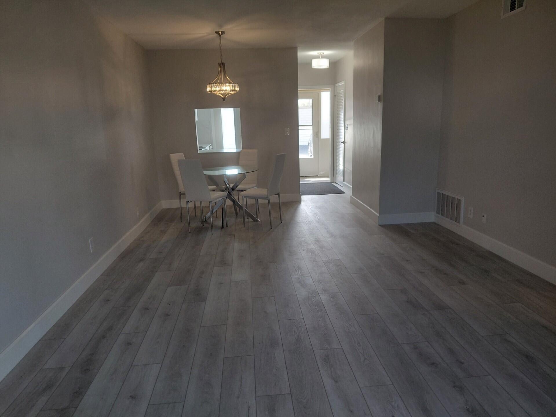 1951 Northeast 39th Street, Unit 127 Lighthouse Point, FL 33064 - Photo 19 of 35 a view of a livingroom with wooden floor and a window