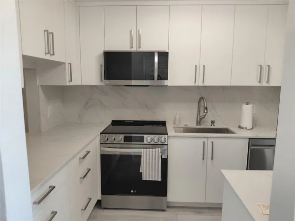 a kitchen with a sink and refrigerator