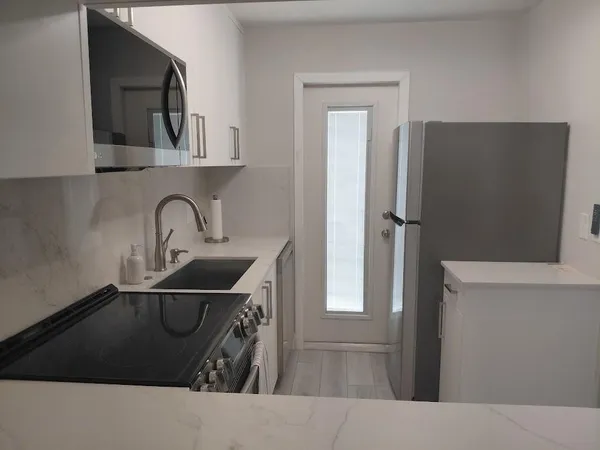 a kitchen with a sink and a stove