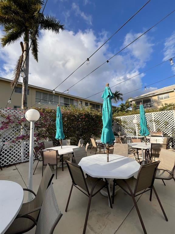 1951 Northeast 39th Street, Unit 127 Lighthouse Point, FL 33064 - Photo 33 of 35 a outdoor space with a table and chairs
