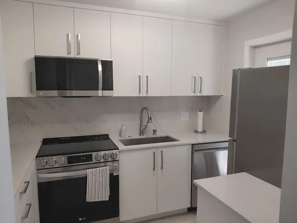 a kitchen with stainless steel appliances a sink a stove and cabinets