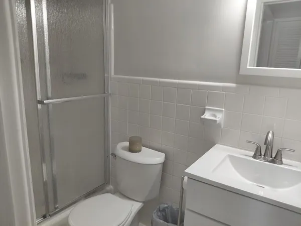 a bathroom with a glass shower door