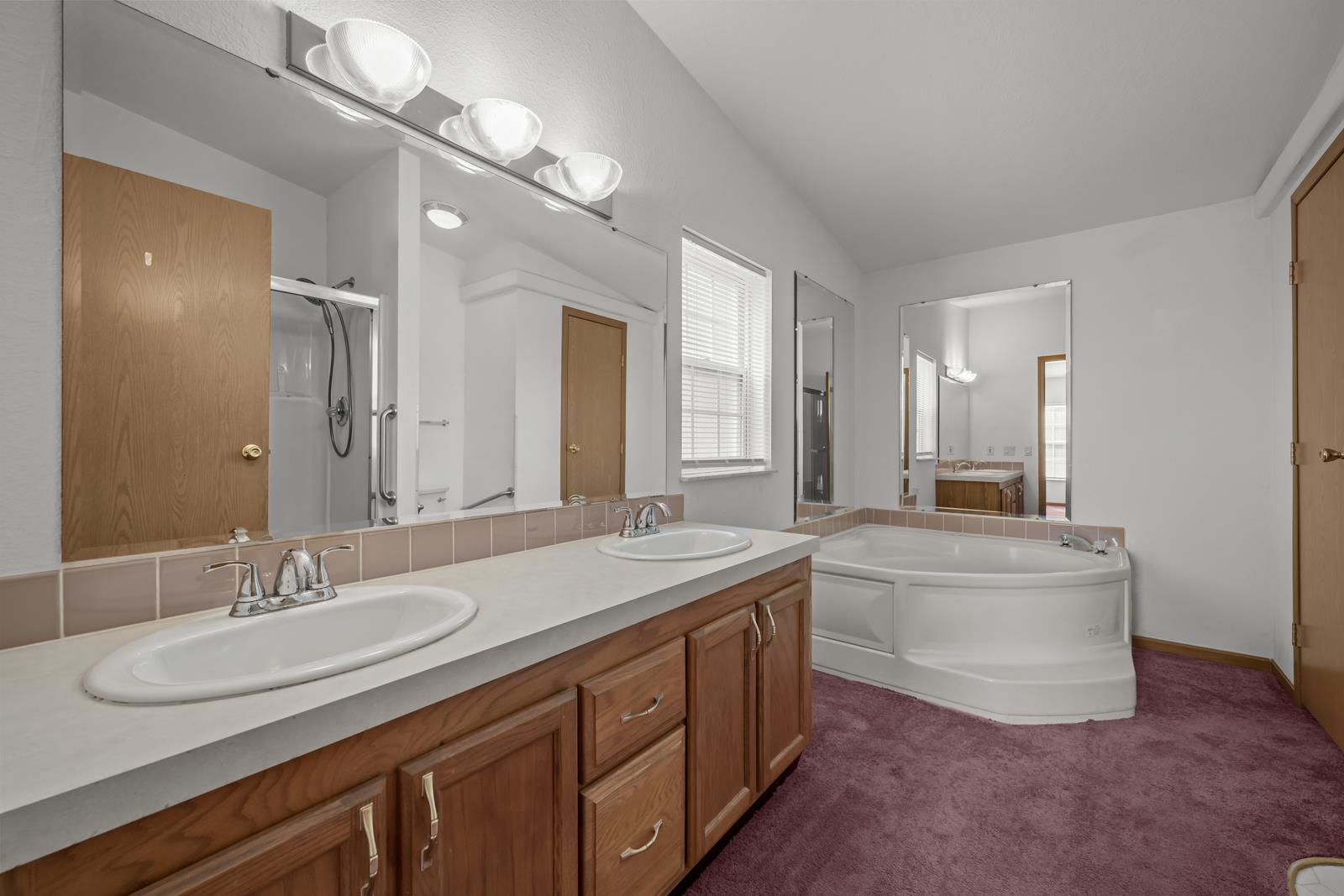 305 Palmetto Bluff Road Palatka, FL 32177 - Photo 14 of 34 Full bathroom featuring a shower stall, double vanity, a bath, dark colored carpet, and lofted ceiling
