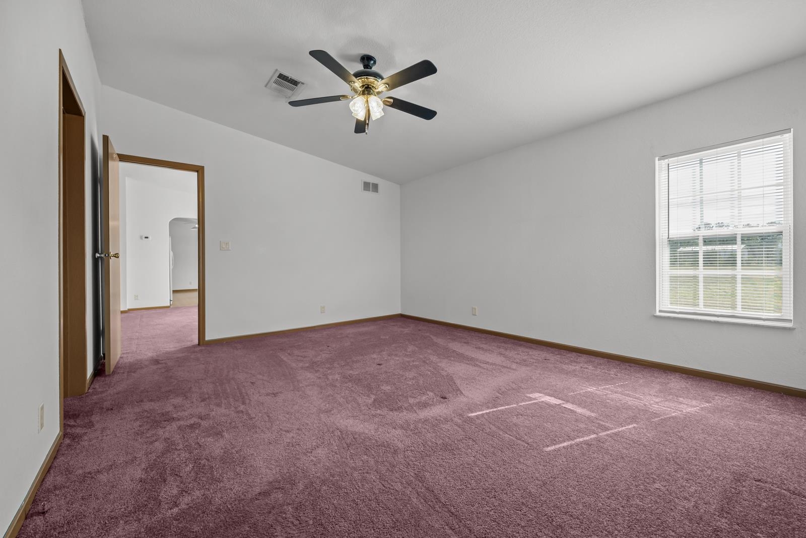 305 Palmetto Bluff Road Palatka, FL 32177 - Photo 15 of 34 an empty room with windows and fan