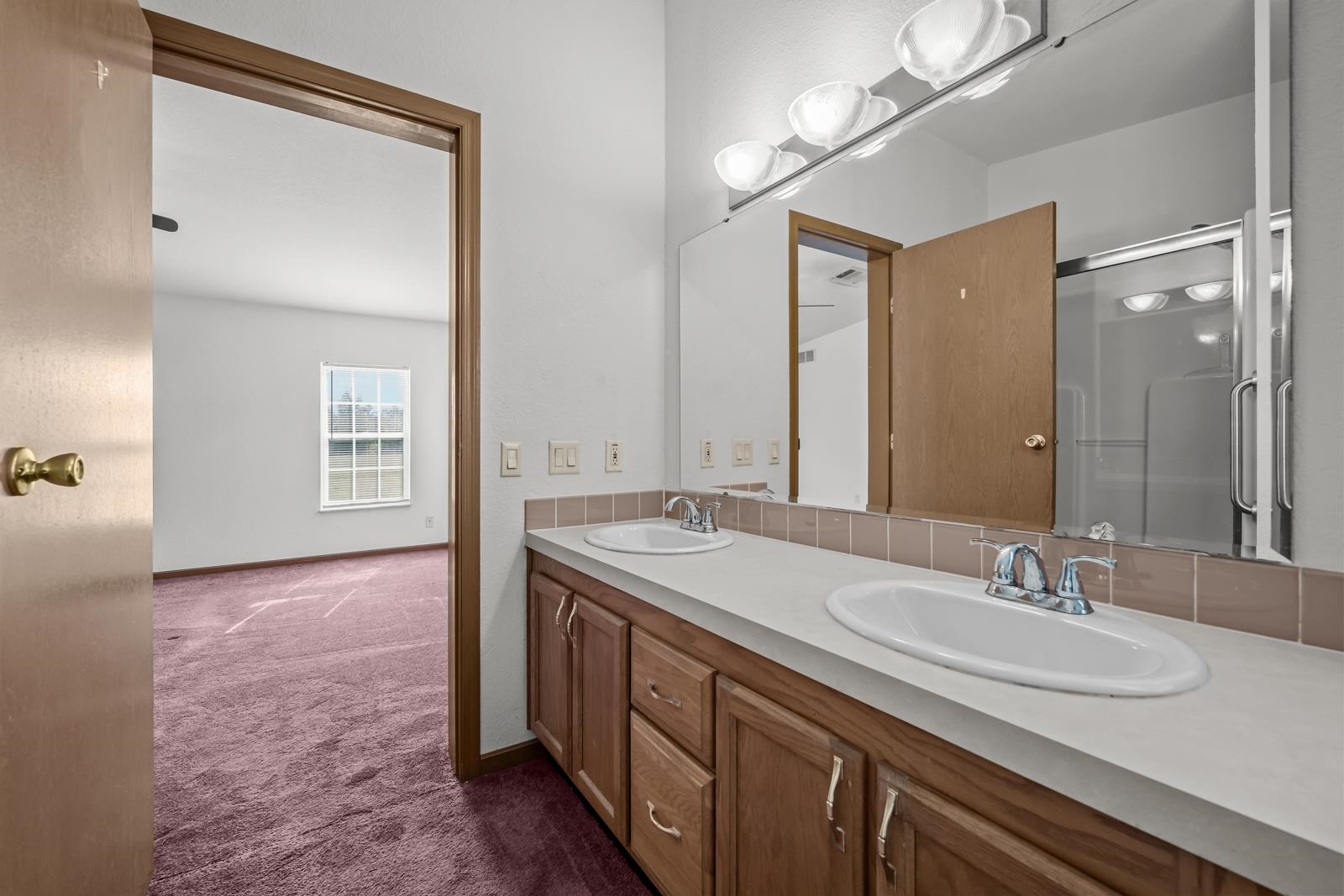 305 Palmetto Bluff Road Palatka, FL 32177 - Photo 18 of 34 Bathroom featuring double vanity, dark carpet, and a shower with shower door