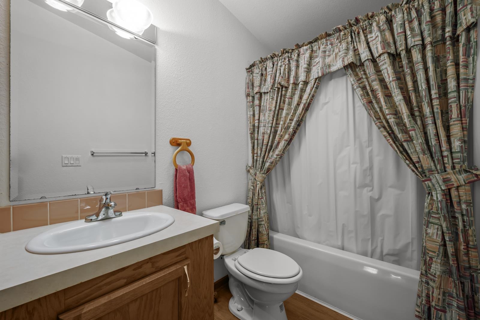 305 Palmetto Bluff Road Palatka, FL 32177 - Photo 19 of 34 Full bath with shower / bath combination with curtain, vanity, a textured wall, lofted ceiling, and wood finished floors