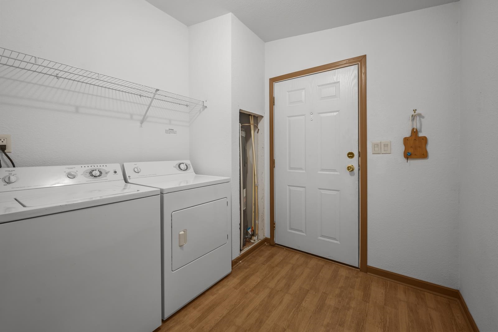 305 Palmetto Bluff Road Palatka, FL 32177 - Photo 23 of 34 Laundry room with light wood finished floors and washing machine and clothes dryer