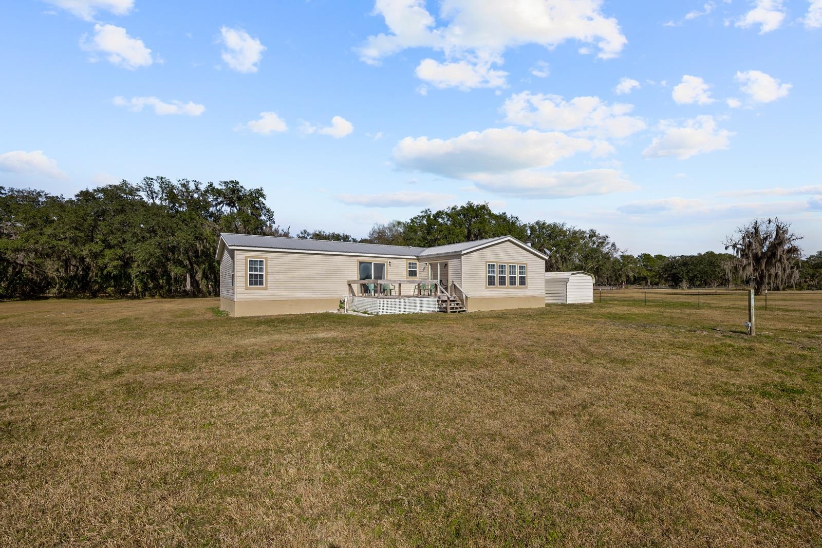 305 Palmetto Bluff Road Palatka, FL 32177 - Photo 26 of 34 Back of property with a wooden deck, a yard.