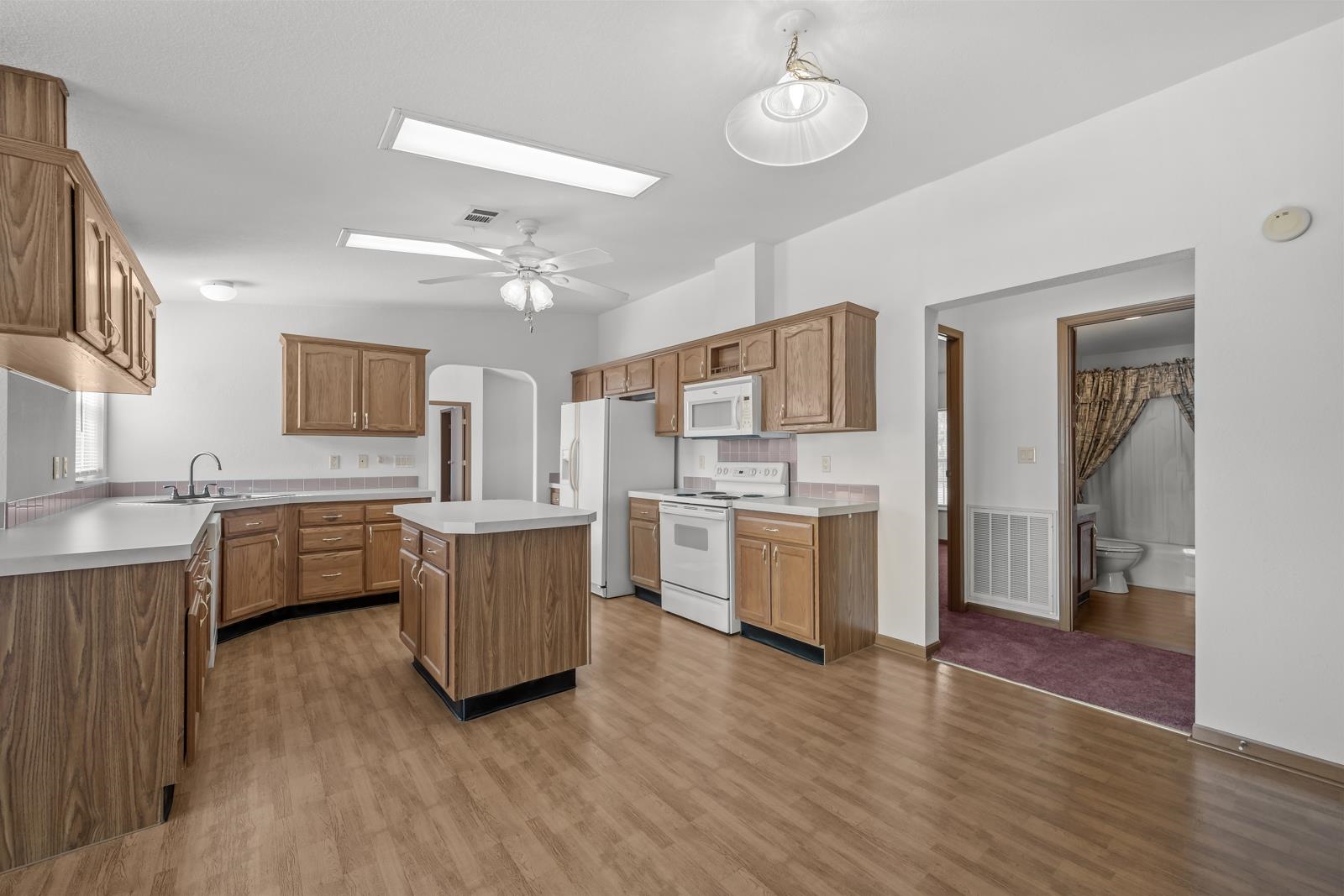 305 Palmetto Bluff Road Palatka, FL 32177 - Photo 8 of 34 a kitchen with stove a sink and white appliances