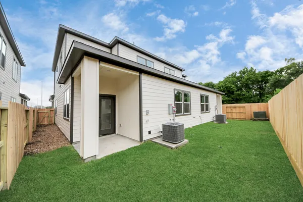 a backyard of a house with table and chairs