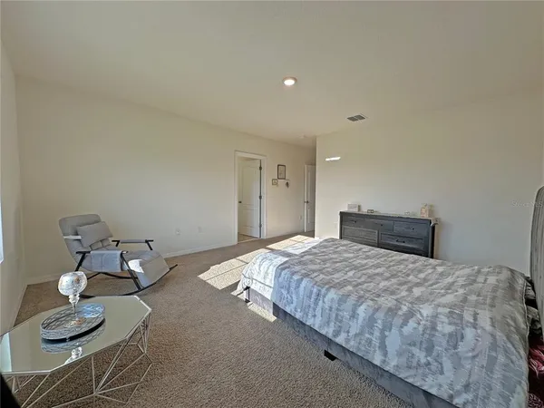 a bedroom with a bed and couch