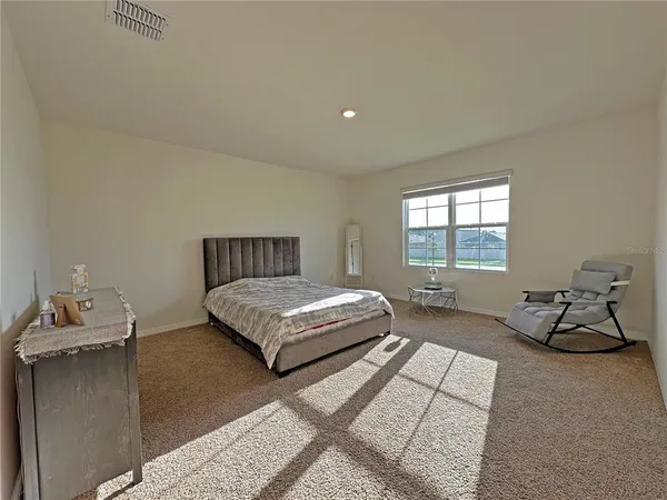 a bedroom with a bed and window