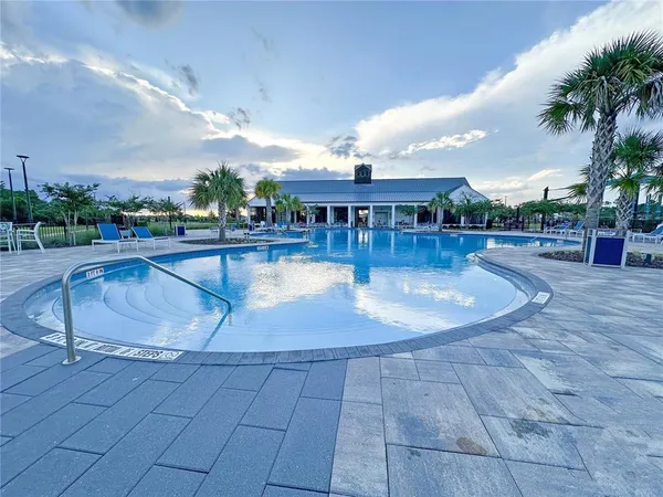 a view of a swimming pool with an outdoor seating