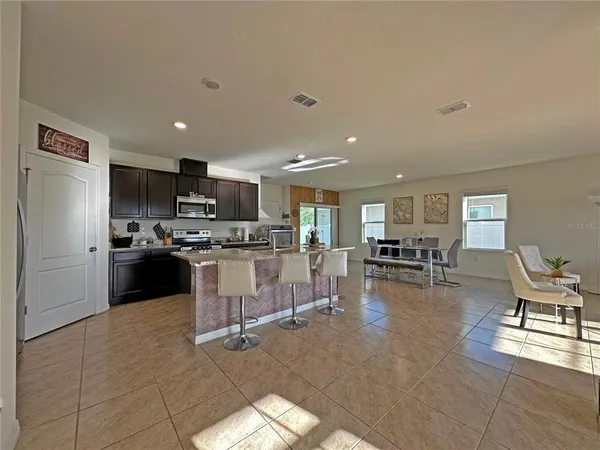 a kitchen with cabinets and chairs