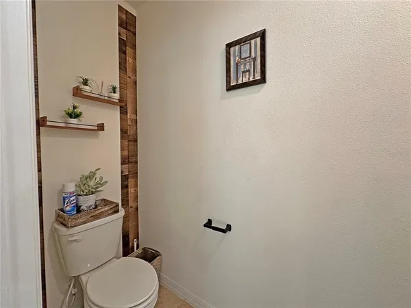 a white toilet sitting next to a bathroom sink