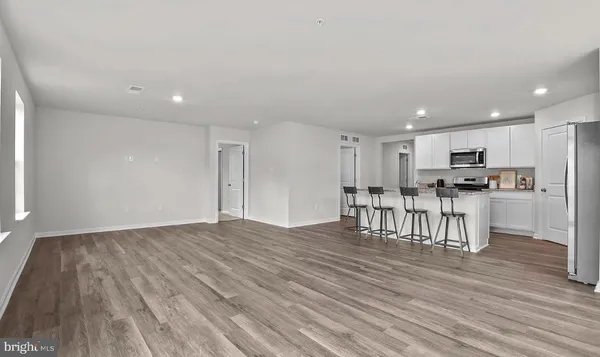 a view of kitchen with stainless steel appliances refrigerator microwave and stove