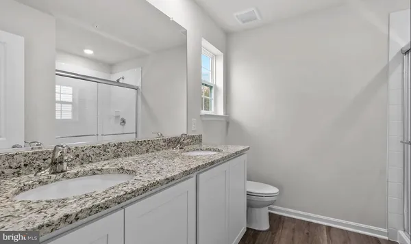 a bathroom with a glass shower door
