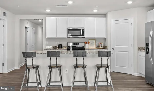 a kitchen with a sink cabinets and microwave