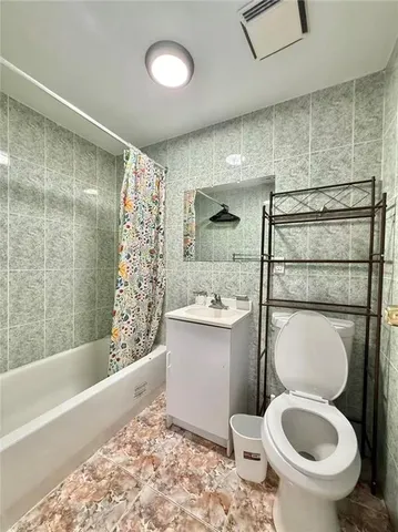 a bathroom with a toilet and a bathtub