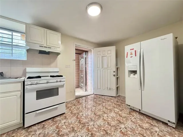 a kitchen with a stove and a refrigerator
