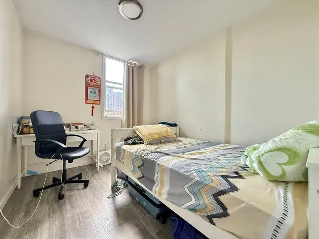 a bedroom with a bed and a chair