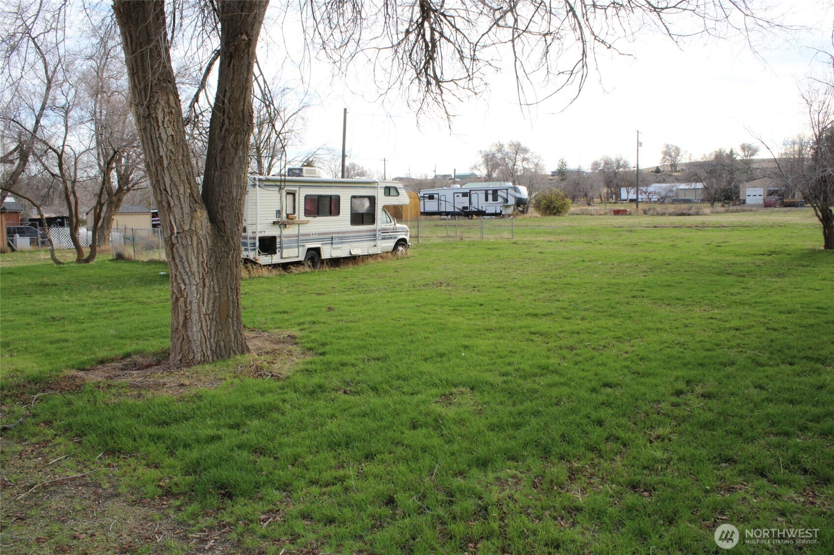 313 West Main Street Lind, WA 99341 - Photo 2 of 5 a white house with a big yard and large trees