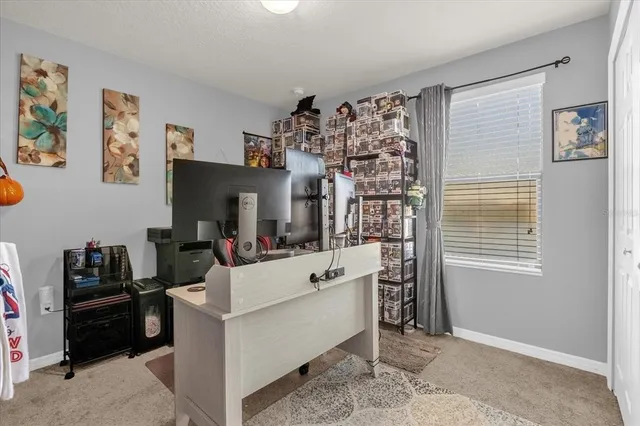 a view of living room and workspace with furniture