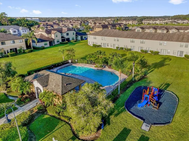 an aerial view of a house with a yard basket ball court and outdoor seating