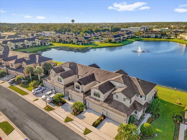 an aerial view of a house with a lake view