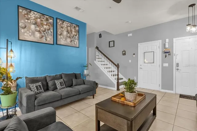 a living room with furniture and a potted plant