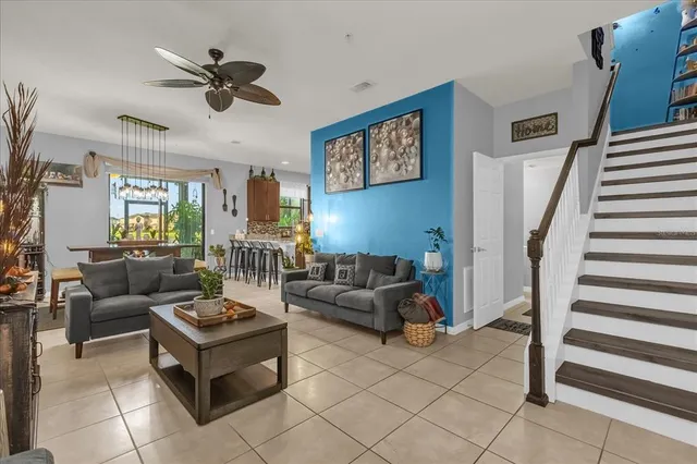 a living room with furniture and a view of kitchen