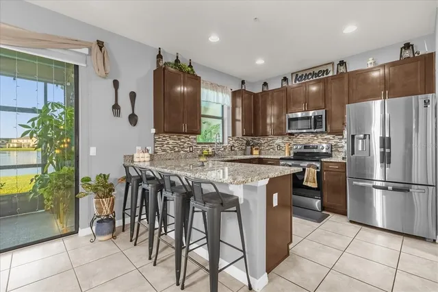 a kitchen with granite countertop a counter space and stainless steel appliances
