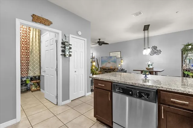 a kitchen with stainless steel appliances granite countertop a sink and a refrigerator