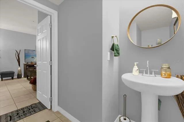 a bathroom with a sink a mirror and a shower