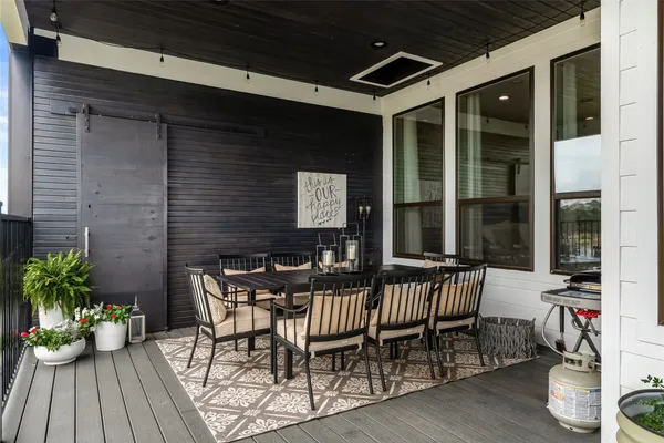 a view of a dinning table and chairs in patio of the house