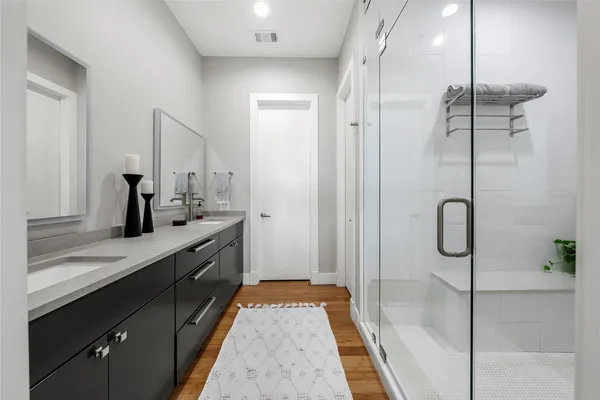 a spacious bathroom with a granite countertop sink mirror and shower