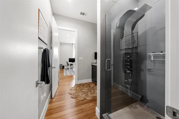 a bathroom with a glass door shower
