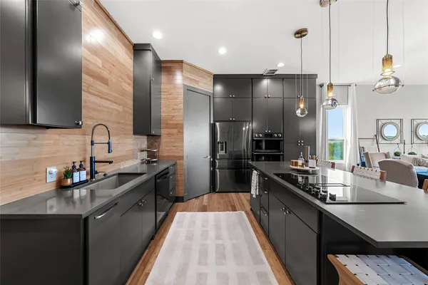 a kitchen with stainless steel appliances a sink stove and refrigerator