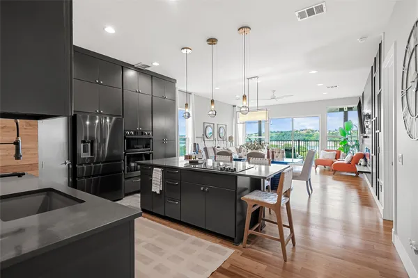 a kitchen with a table chairs refrigerator and cabinets