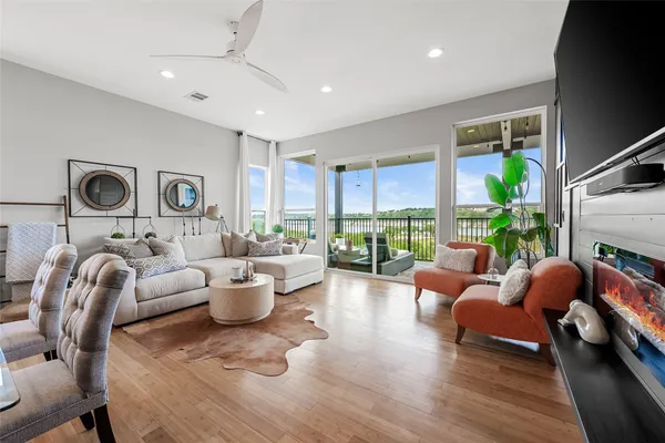 a living room with furniture fireplace and a large window